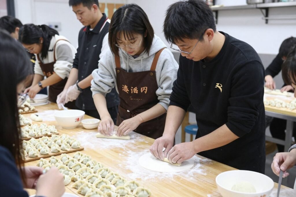Cooking class students learning to make dumplings
