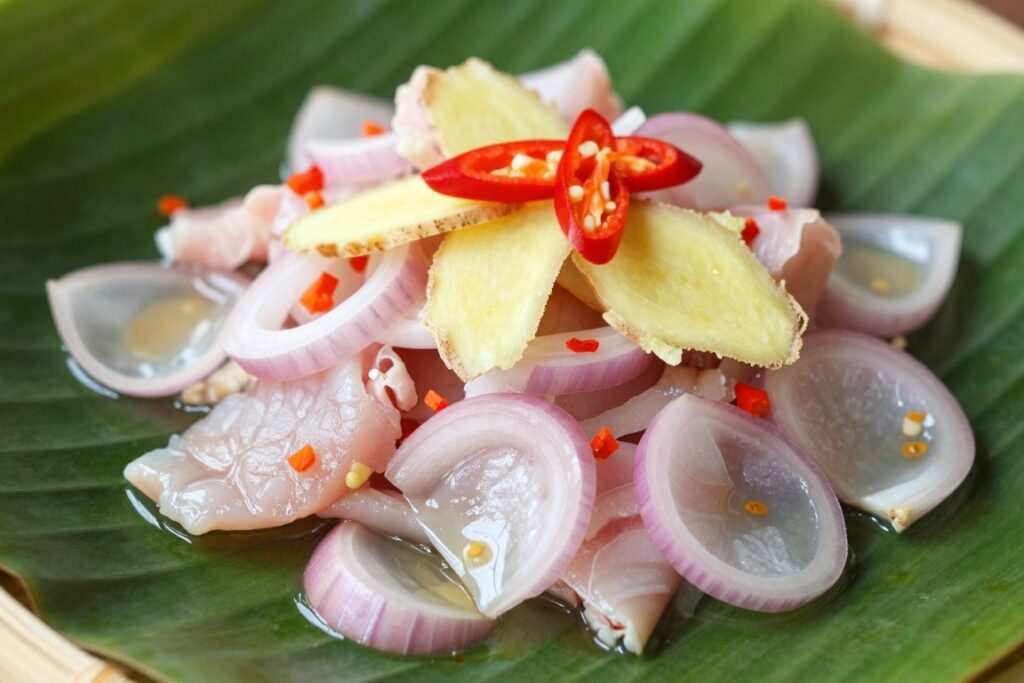 Fresh hinava raw fish salad dish served with lime and chilies