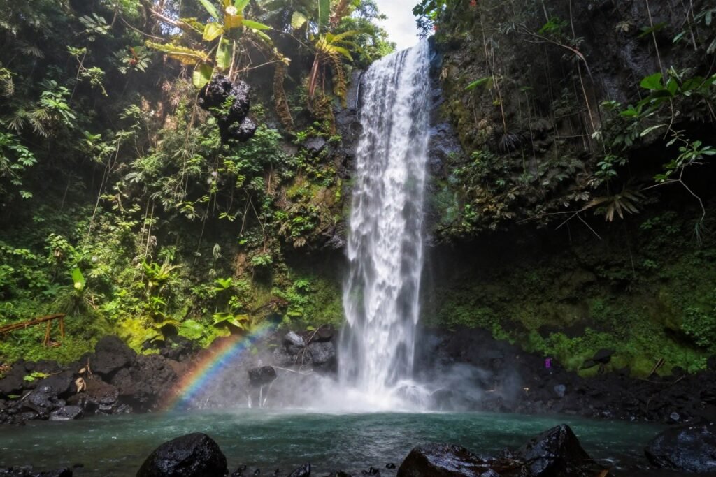 Hidden waterfall in North Bali jungle with natural pool