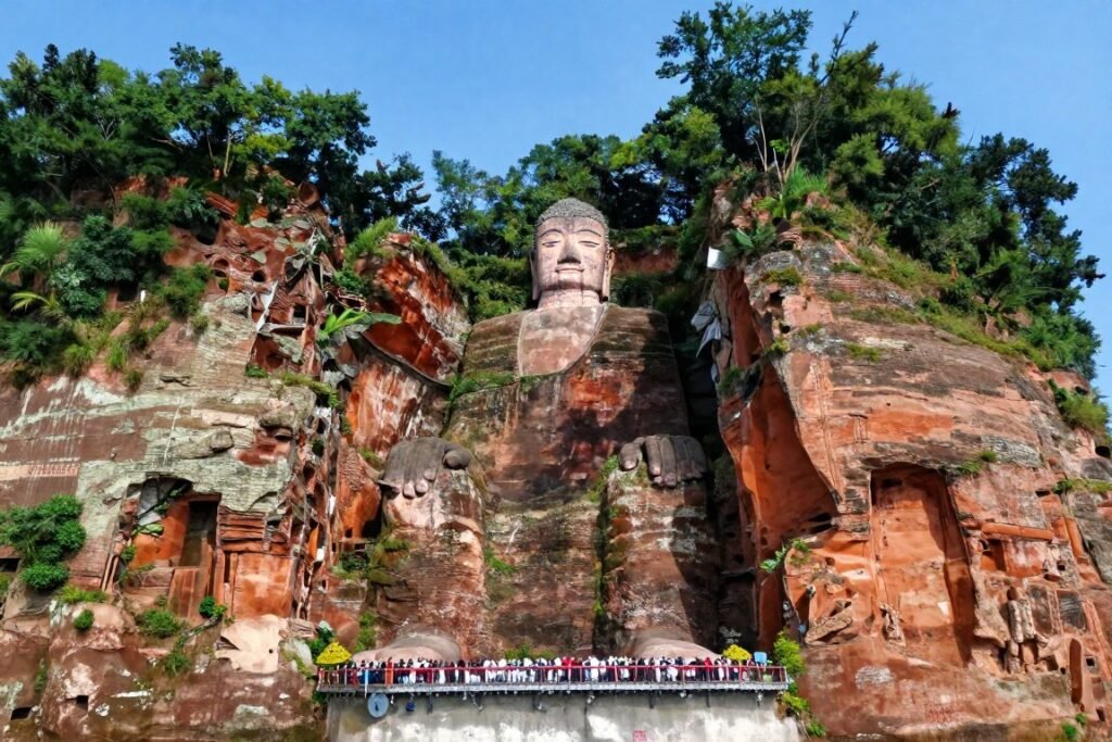 Leshan Giant Buddha carved into cliff face with river and mountains