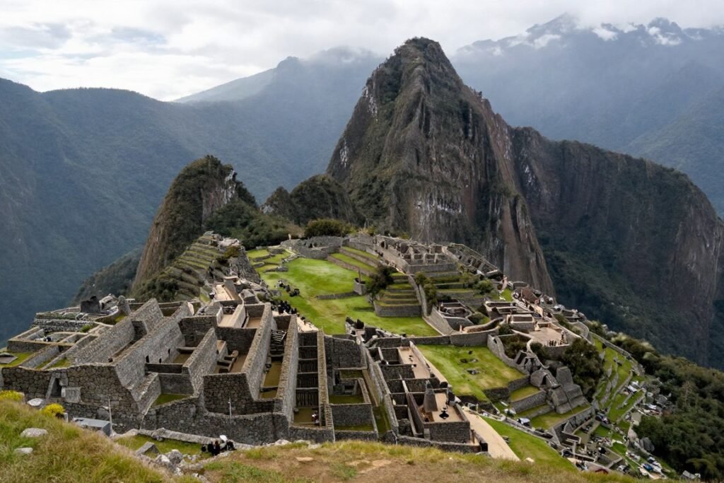Machu Picchu Incan ruins on mountain top with Huayna Picchu peak behind