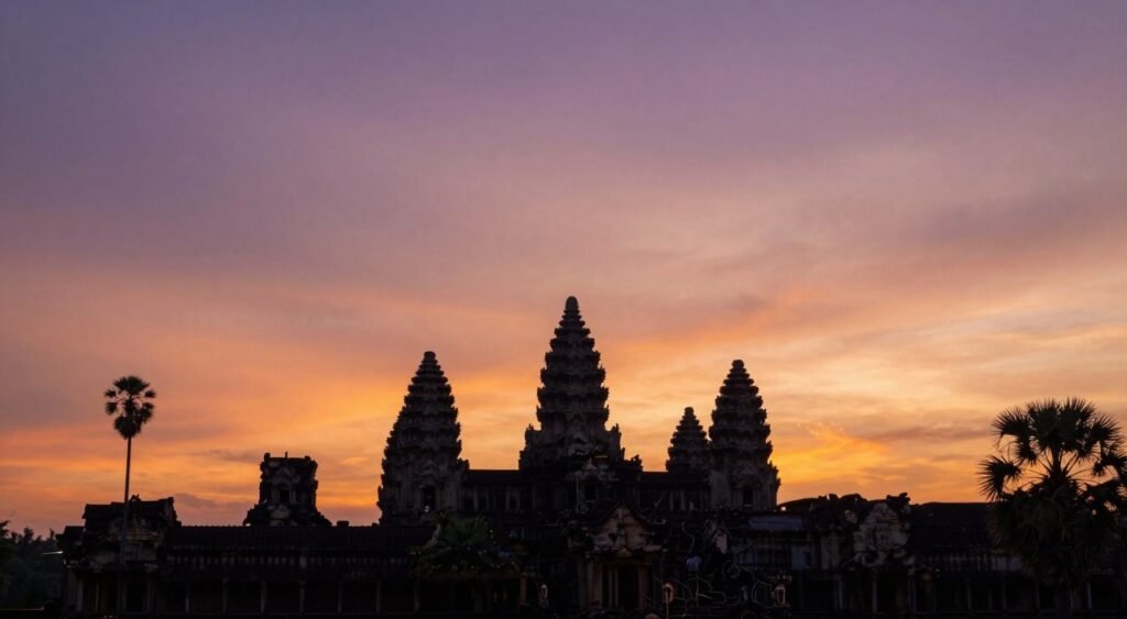 Peaceful sunset over Angkor temple spires with orange sky Peaceful sunset over Angkor temple spires with orange sky