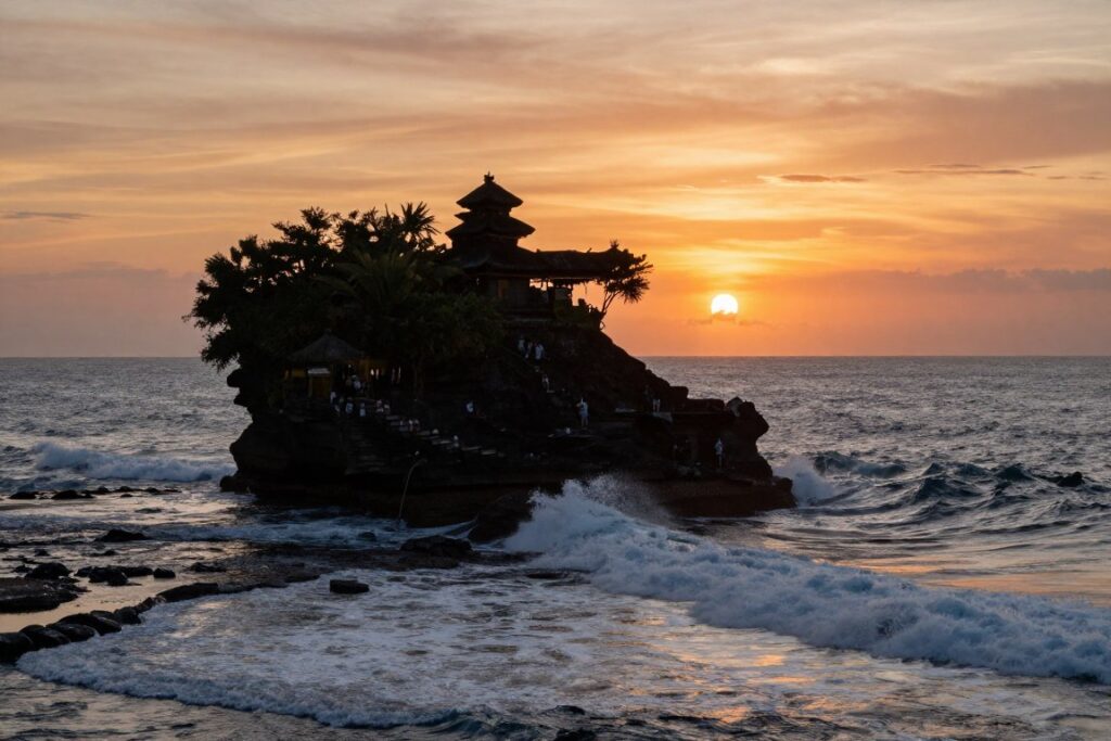Tanah Lot temple at sunset with waves crashing