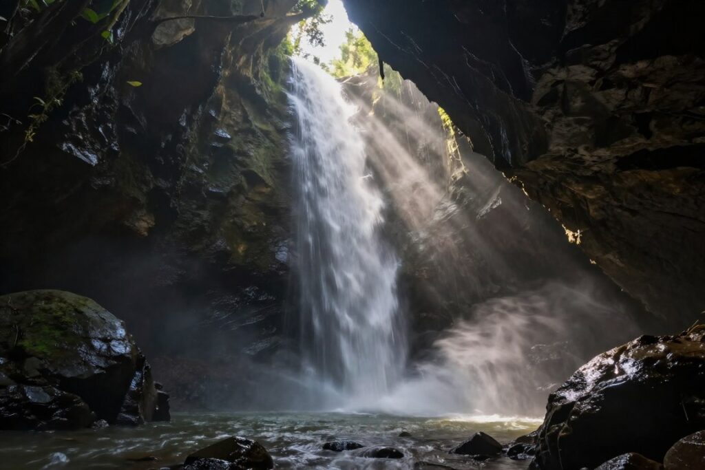 Tukad Cepung waterfall with sunbeams through canyon opening